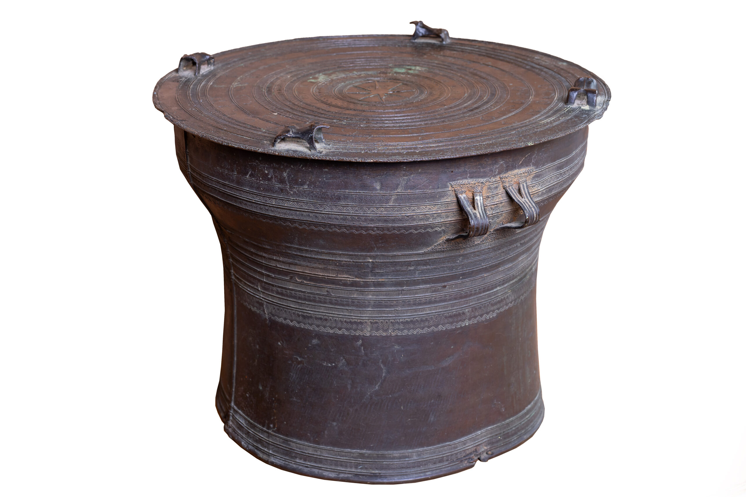 cast bronze, the circular tops with central stellate medallion, surrounded by concentric ridges in low relief, four stylised frogs around the edge, the sides with two pairs of loop handles and ridged decoration35cm high; 48cm diam.This type of drum was traditionally made in the Shan states for the Karen people. The drum would be beaten during a ritual to encourage rainfall to enable the harvest. The Karen are a major ethnic group in Burma with origins in Yunnan province in China. See Richard M. Cooler, 'The Karen Bronze Drums of Burma: Leiden 1995