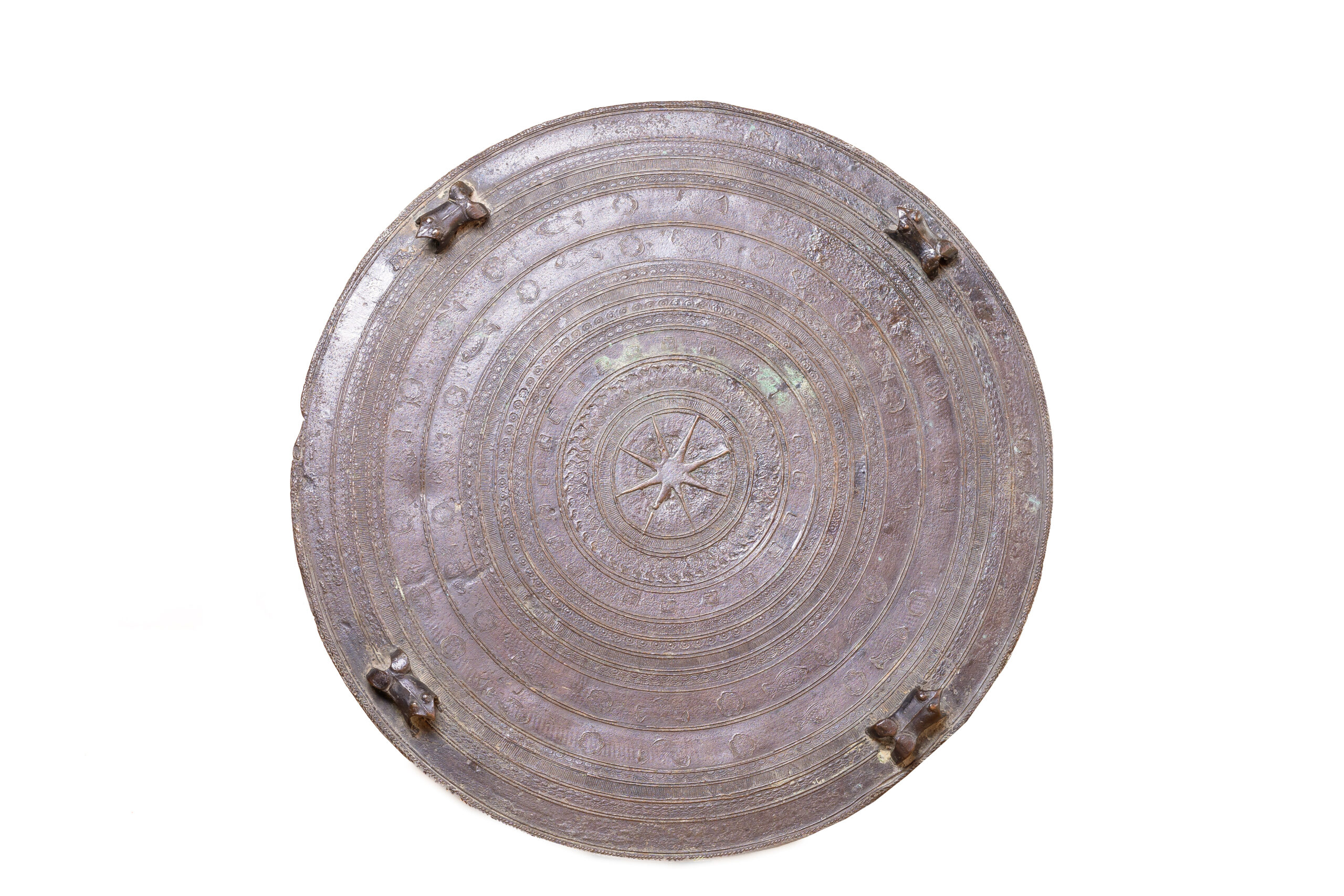 cast bronze, the circular tops with central stellate medallion, surrounded by concentric ridges in low relief, four stylised frogs around the edge, the sides with two pairs of loop handles and ridged decoration35cm high; 48cm diam.This type of drum was traditionally made in the Shan states for the Karen people. The drum would be beaten during a ritual to encourage rainfall to enable the harvest. The Karen are a major ethnic group in Burma with origins in Yunnan province in China. See Richard M. Cooler, 'The Karen Bronze Drums of Burma: Leiden 1995 top