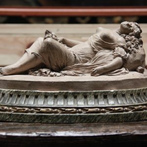 A Terracotta Group of a reclining scantily clad maiden with her dog French circa 1900.