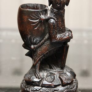 A Charming Swiss carved black Forest toothpick or match holder in the form of an anthropomorphic hound Circa 1890