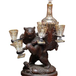 A Swiss Carved Linden Wood Black Forest Bear Liqueur set with gilded decanter and glasses circa 1900.